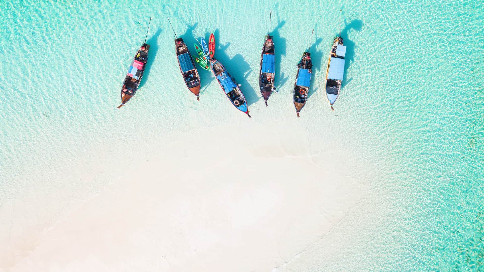 Thailand islands beach with traditional boats